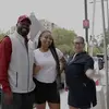 An animated photo of a new Temple first-year student and her parents smiling and waving at the camera