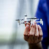 Philip Dames holds a small drone robot