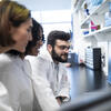 Three center researchers collaborating in the lab