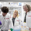 Three center researchers work in the lab