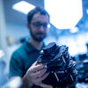 Philip Dames holding a part of one of his robots