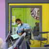 A dentist cleans a student's teeth at the children's clinic at William Kelley elementary school