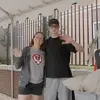 A Temple student and his parent waving and smiling on move in day