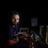 Eric Cordes sitting in his lab watching deep sea footage