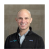 A professional headshot of Eric Herzog