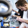 A Temple student working on an engineering project, connecting wires.